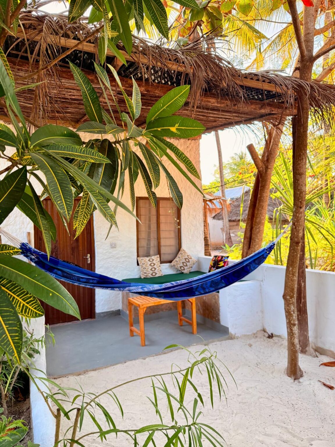 Bungalow with terrace, hammock and view of the tropical garden.